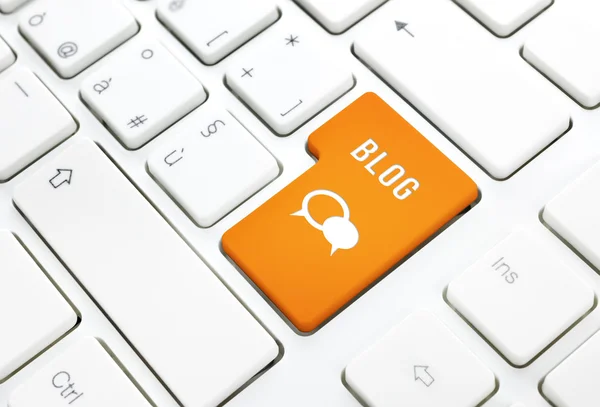Блог бізнес-концепція, текст і значок. Помаранчева кнопка або клавіша на білій клавіатурі Ліцензійні Стокові Фото