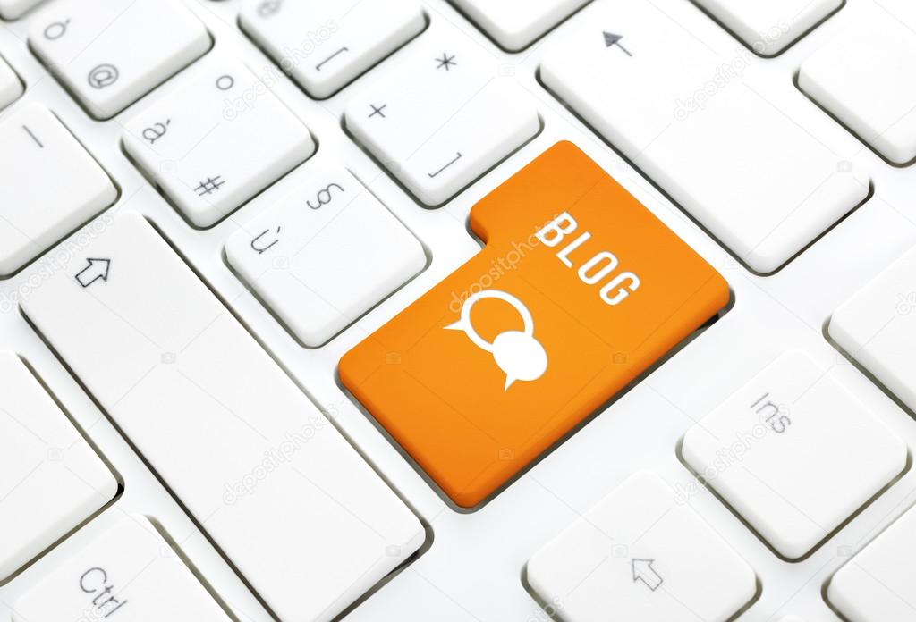 Blog business concept, text and icon. Orange button or key on white keyboard