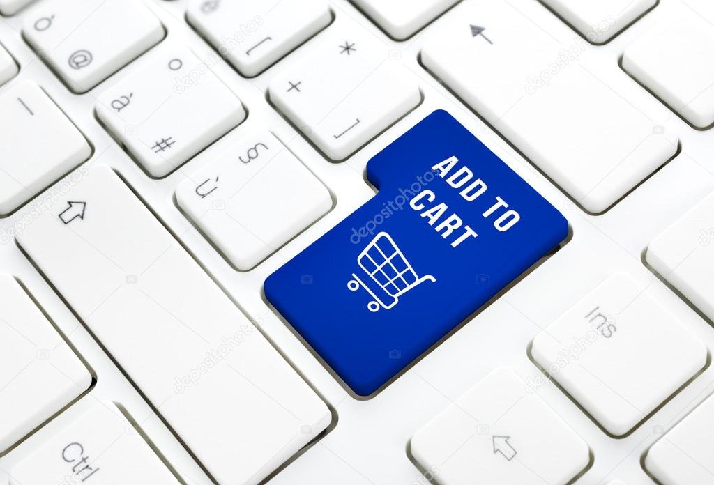 Shop add to cart business concept. Blue shopping cart button or key on white keyboard