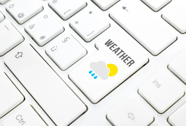 Weather on web concept. Sun cloud rain icon on a key on white keyboard — Stock Photo, Image