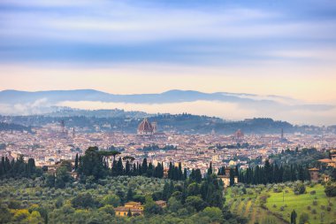 Florence aerial foggy morning cityscape. Panorama view from Fiesole hill, Italy clipart