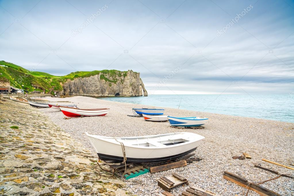Etretat village, bay beach, Aval cliff and boats. Normandy, France.