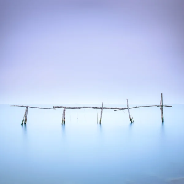 Poles and soft water on water landscape. Long exposure. — Stock Photo, Image