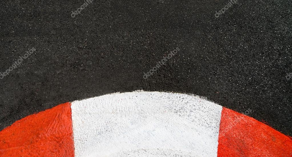 Texture of race asphalt and curved curb Grand Prix circuit