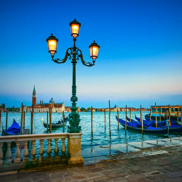 Venice, street lamp and gondolas or gondole on sunset and church — Stock Photo, Image