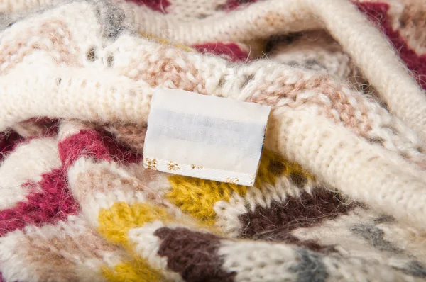 Price tag on the background of a knitted fabric — Stock Photo, Image