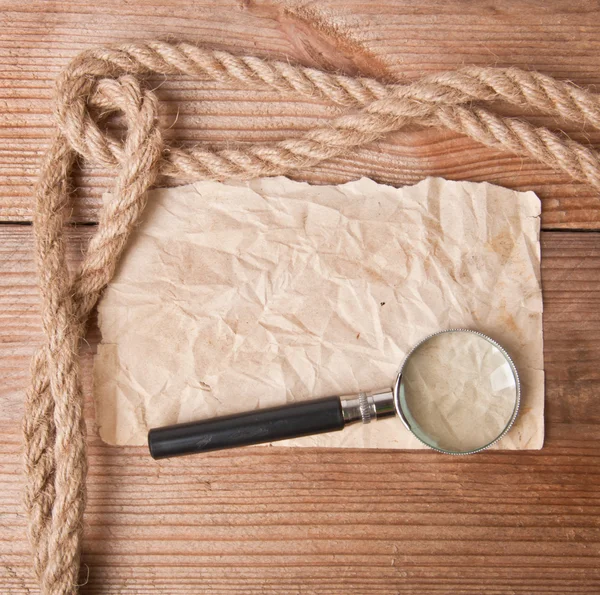 Old paper and magnifier — Stock Photo, Image