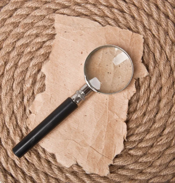 Magnifying glass and old paper — Stock Photo, Image