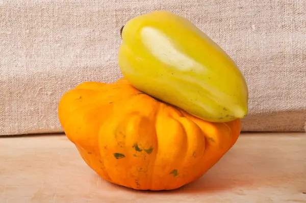 Peppers and squash on a wooden background — Stock Photo, Image