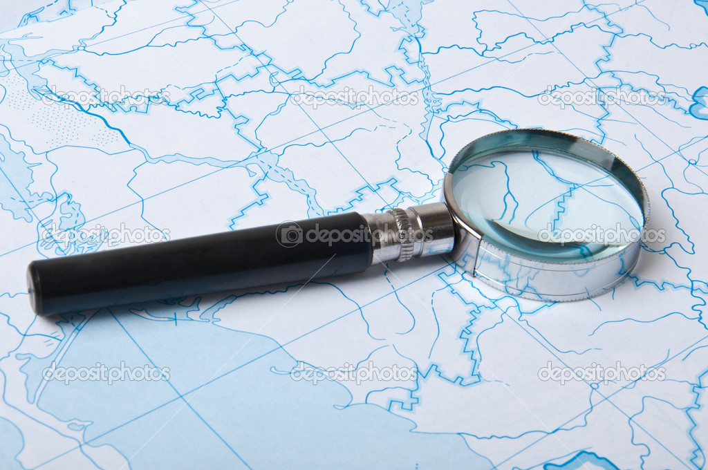 Magnifying glass on the map background