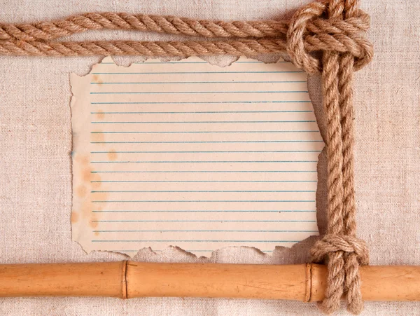 Knot and old paper on the background of old cloth — Stock Photo, Image