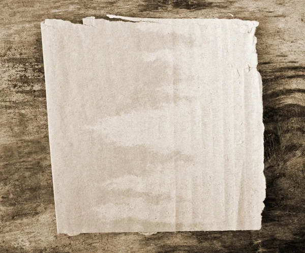 Paper on old wooden background — Stock Photo, Image