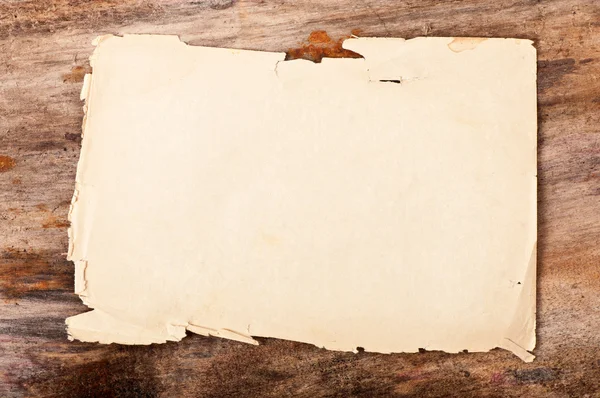 Paper on old wooden background Stock Photo