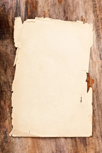 Paper on old wooden background Stock Picture
