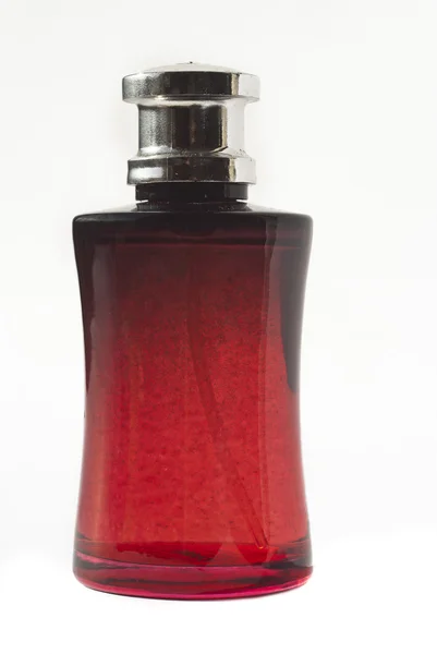 Parfym i röd flaska — Stockfoto