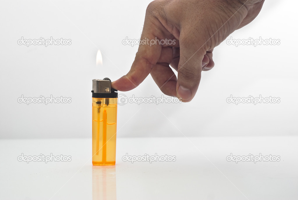 Male hand holding a orange lighters isolated