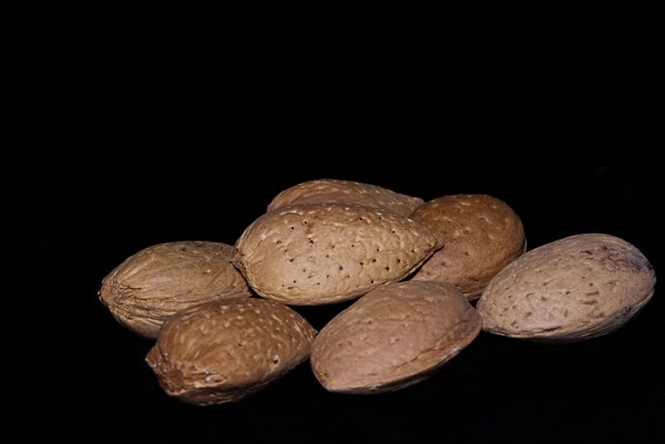 Almonds isolated on a black — Stock Photo, Image