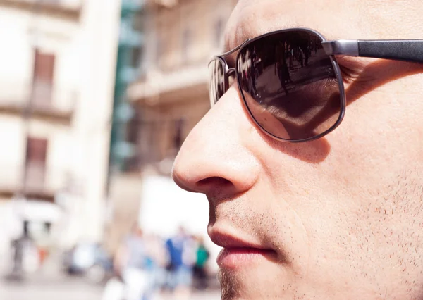 portrait of a attractive gorgeous guy wearing sunglasses