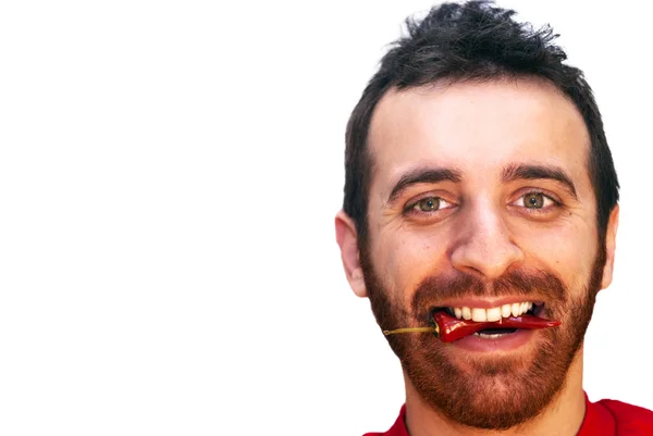 Man with a red hot chili pepper in his mouth — Stock Photo, Image