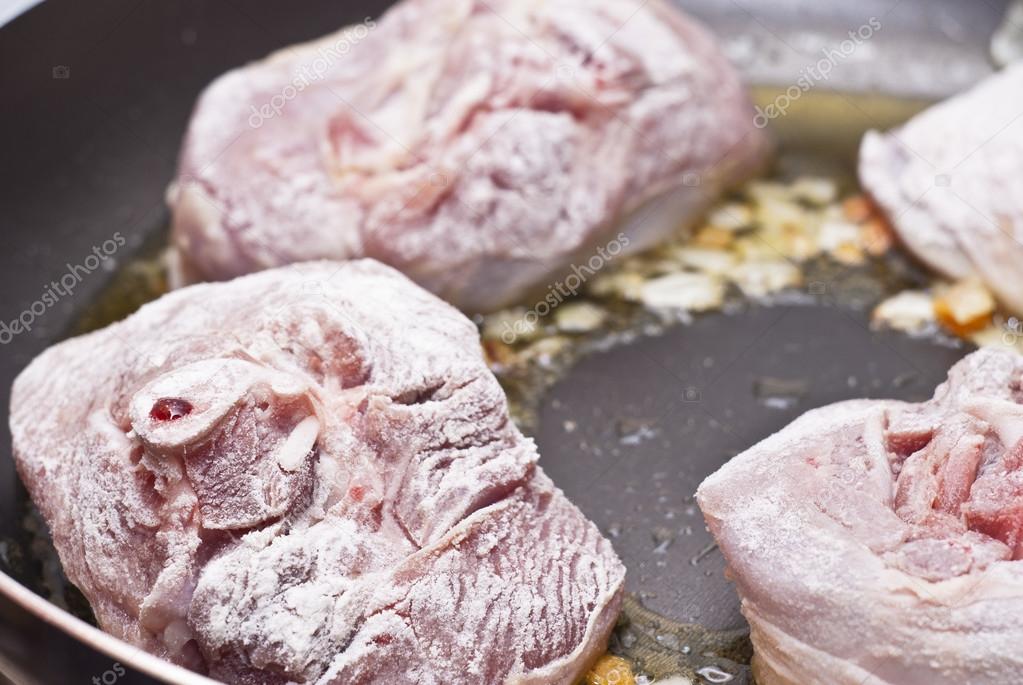 floured osso buco in pan