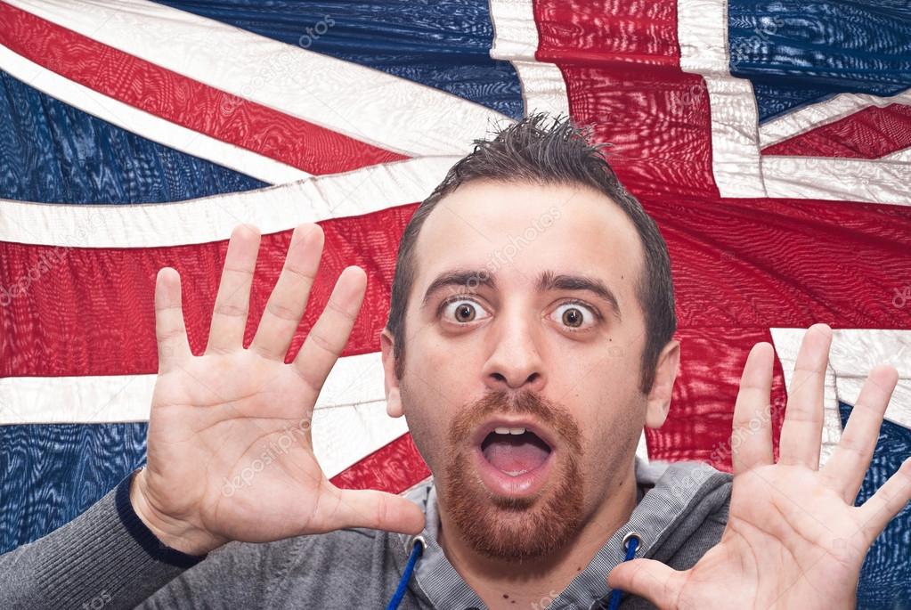 young amazed man portrait with british flag