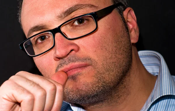 Pensive bearded caucasian man wearing eyeglasss — Stock Photo, Image