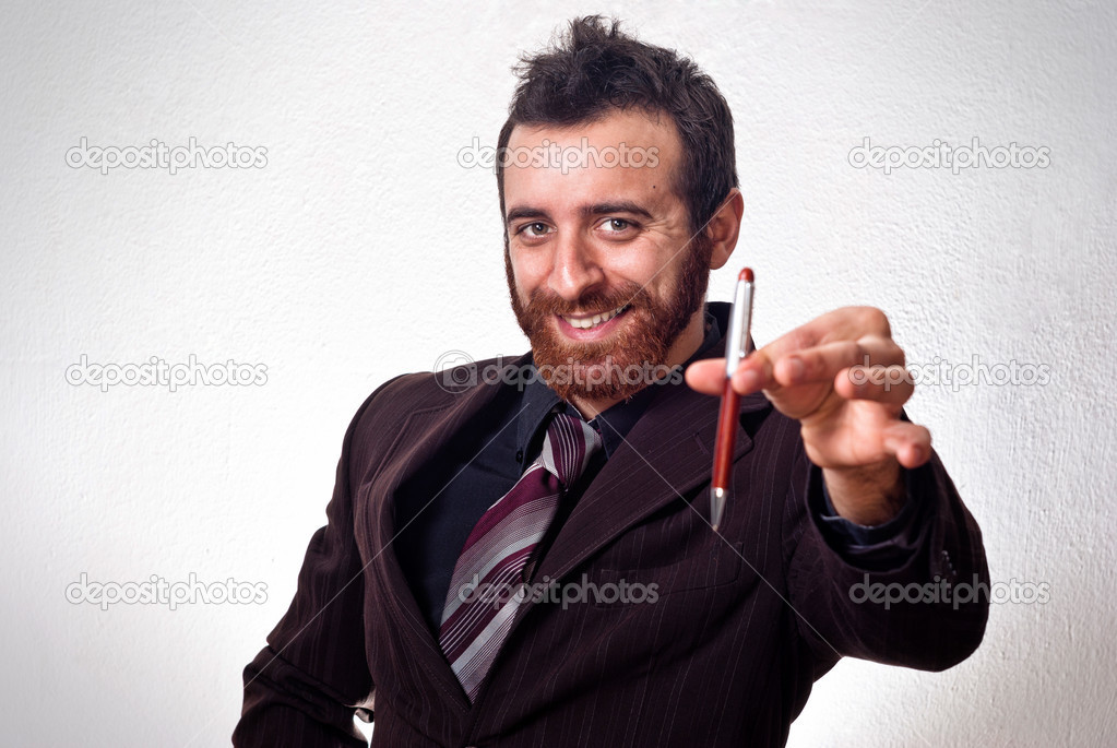 happy businessman handing a pen to sign the contract