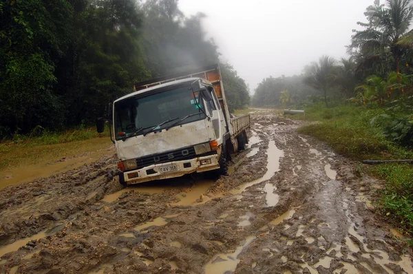 Stuck truck at muddy road — Stock Photo, Image