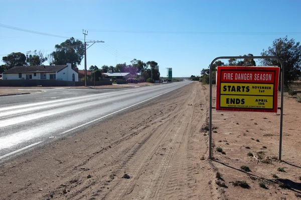 Road fire safety sign on highway in outback — Stock Photo, Image