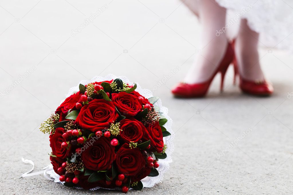 Wedding bouquet and bride's feet