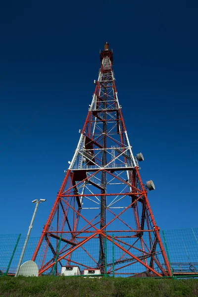 Telecom broadcasting tower under blue sky Stock Image