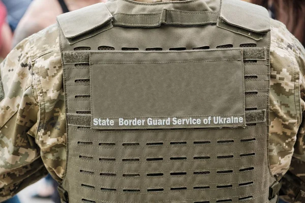 Member of the Ukrainian State Border Guard stand watch at the border crossing. View from the back. State Border Guard Service of Ukraine.