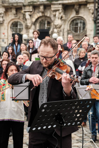 Lviv, Ukraine - March 16, 2022: Symphony Orchestra performed on Market Square in Lviv as part of the Free Sky art campaign in support of the call to close the sky over Ukraine