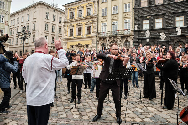 Lviv, Ukraine - March 16, 2022: Symphony Orchestra performed on Market Square in Lviv as part of the Free Sky art campaign in support of the call to close the sky over Ukraine