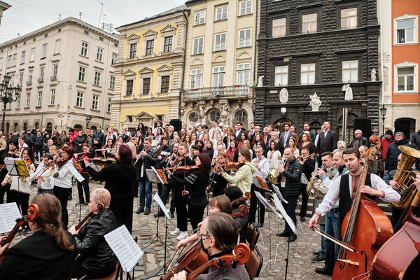 Lviv, Ukraine - March 16, 2022: Symphony Orchestra performed on Market Square in Lviv as part of the Free Sky art campaign in support of the call to close the sky over Ukraine