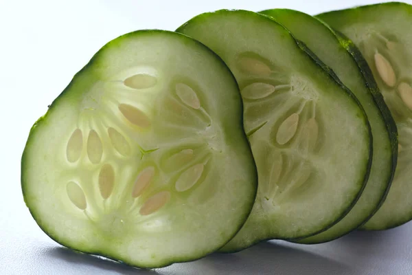 Fresh, green cucumber slice macro photo. Close-up of fresh cucumber with seeds.