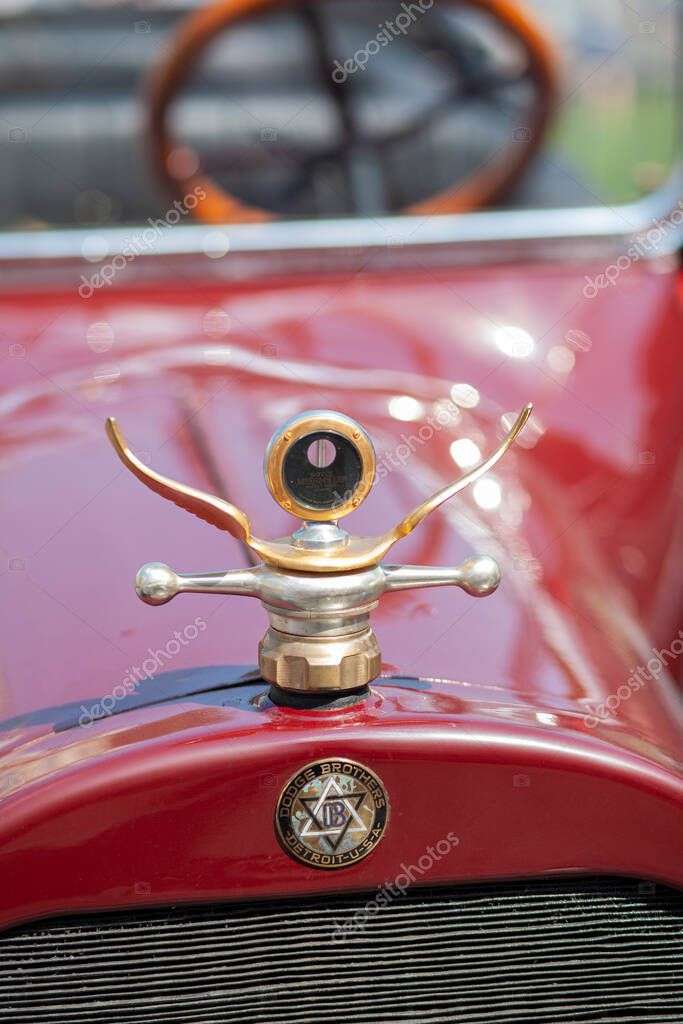 LVIV, UKRAINE - June 21, 2013: Boyce Motometer thermostat in the form of car emblem. Dodge Brothers logo on vintage car. Selective focus