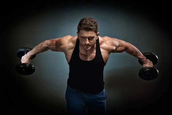 Athletic young man exercising — Stock Photo, Image