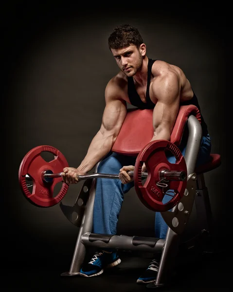 Athletic young man lifting weights Stock Photo
