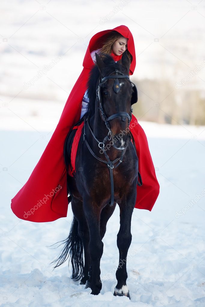 beautiful woman with red cloak with horse outdoor