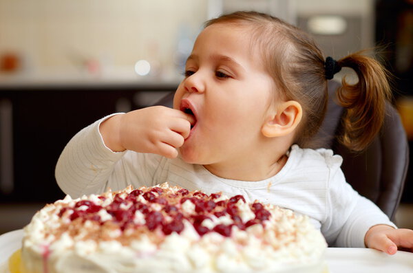 cute little girl eating cake