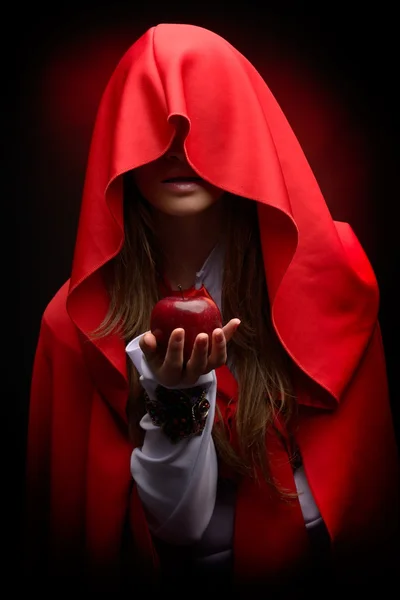 Beautiful woman with red cloak hoding apple — Stock Photo, Image