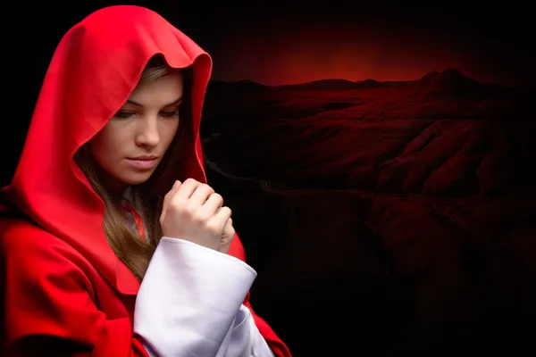 Beautiful woman with red cloak in studio — Stock Photo, Image