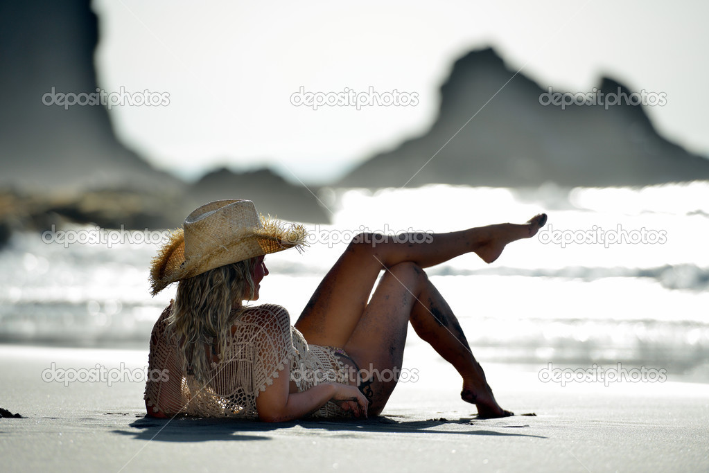 young woman relaxing on the beach in summer