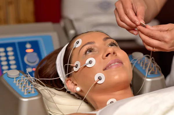 Giovane donna sorridente durante il trattamento cosmetico — Foto Stock