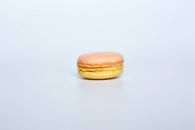 Beyaz arka planda makarun, beyaz arka planda bir badem kurabiyesi bulunur.