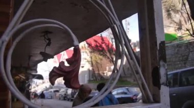 İnsanlar sokağın yanından geçiyor ve ağaçlar soldan sağa kayıyor.