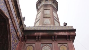 Building Tower And Colorful Walls - Tilt - Up To Down