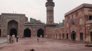 Little Boy Running Near People In Mosque From Inside - Pan - Right To Left