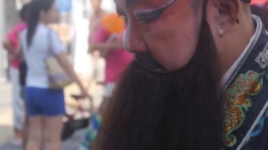 Man Wearing Makeup Surrounded By People In Street - Close Up And Handheld